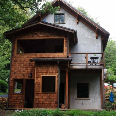 Back of house faces a creek and has a complex array of outdoor rooms