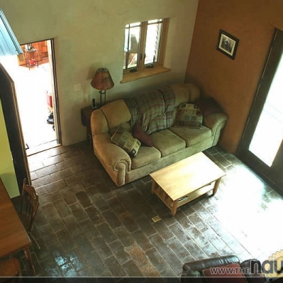 Indoor living room with site-made compressed earth block floor and two types of earthplaster