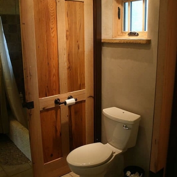Sliding barn door separating half bath from shower