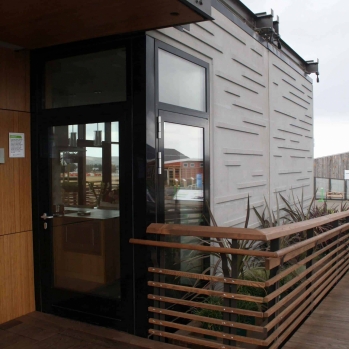 The front entrance is approached from the street and protected by a cantilevered roof.