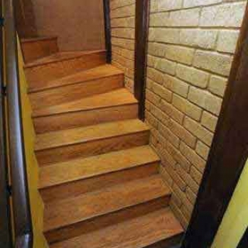 Site-made compressed earth block walls in the stairwell. The downstairs can function as a separate apartment or business.