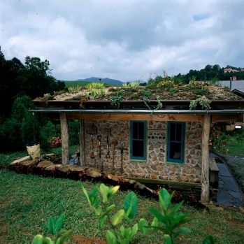 The cordwood wall is set under the deep eave overhangs to create an outdoor room...